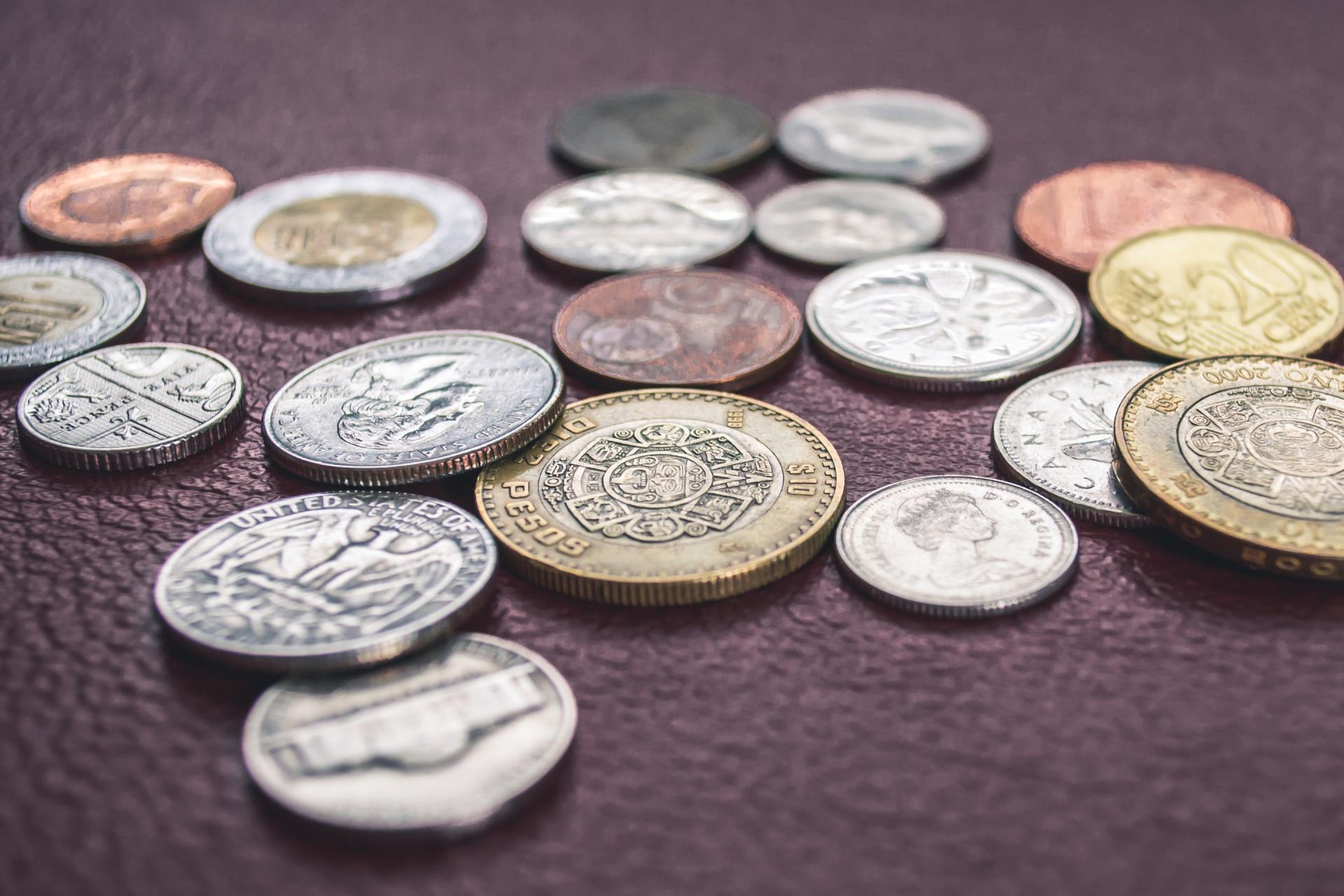 There are many different types of coins on the table.
